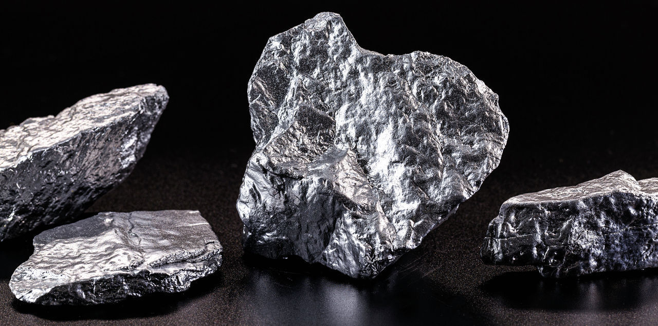 CLOSE-UP OF ROCKS ON TABLE AGAINST ROCK