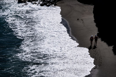 People on frozen sea during winter