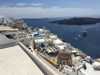 High angle view of buildings by sea against sky