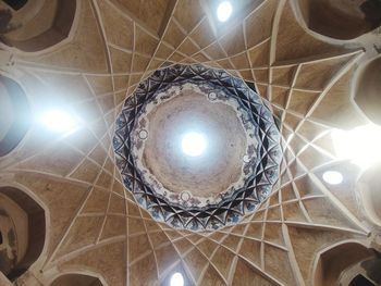 Low angle view of illuminated pendant light hanging from ceiling