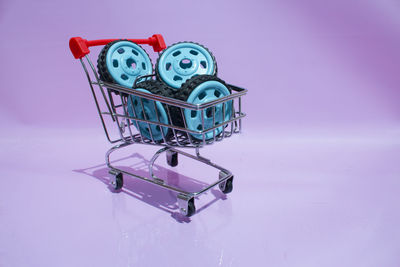 Close-up of empty blue glass on table against pink background