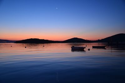 Scenic view of lake at sunset