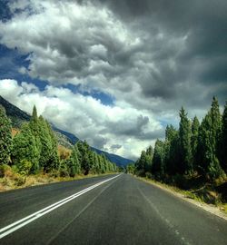 Scenic view of road against cloudy sky