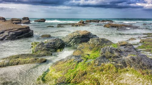 Scenic view of sea against cloudy sky