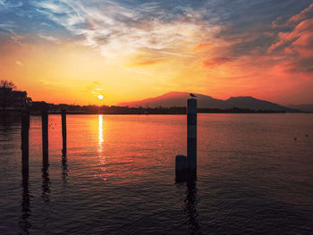 Scenic view of sea against romantic sky at sunset