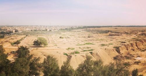 Scenic view of sand dunes against sky