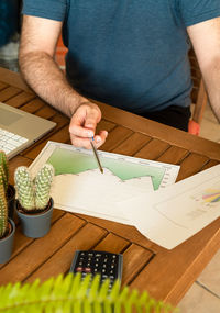 High angle view of man sitting on table