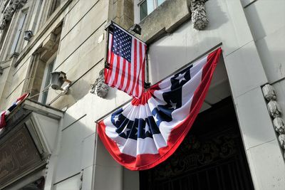 Low angle view of flags hanging on building
