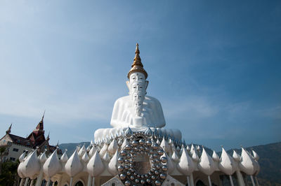 Low angle view of buddha statues at wat pha son kaew against sky