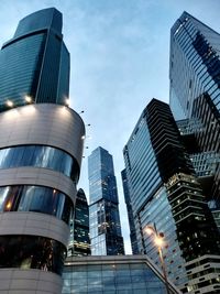 Low angle view of modern buildings against sky at dusk