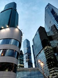 Low angle view of buildings against sky at dusk