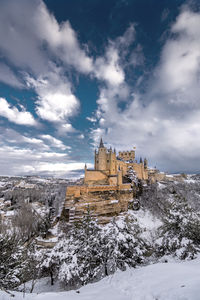 View of historic building against cloudy sky during winter
