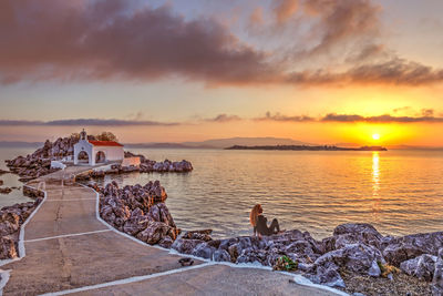 Scenic view of sea against orange sky