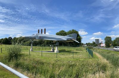 Airplane on field against sky