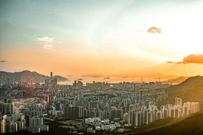 Buildings in city against sky during sunset