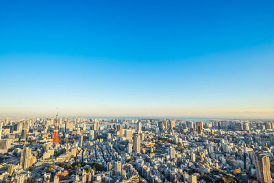 Aerial view of cityscape against clear sky during sunset