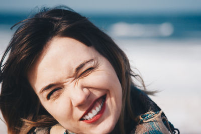 Close-up portrait of smiling young woman