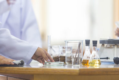 Midsection of man working on table in laboratory