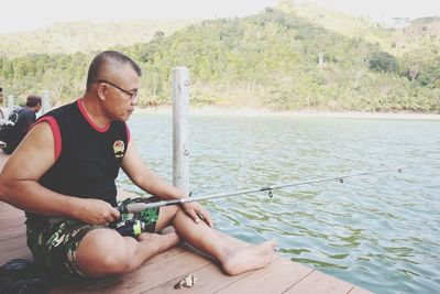 Mature man fishing in lake