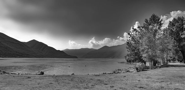 Scenic view of sea and mountains against sky