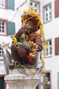 Close-up of statue against building in city