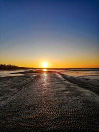 Scenic view of sea against clear sky during sunset