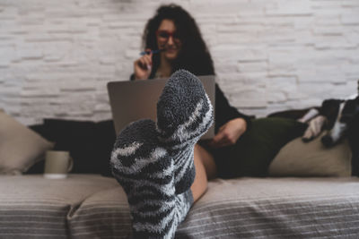 Portrait of woman sitting on bed at home