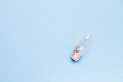 High angle view of light bulb over white background