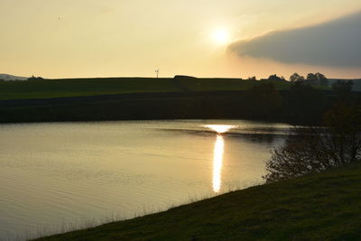 Scenic view of lake against sky during sunset