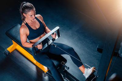 Side view of young man playing guitar