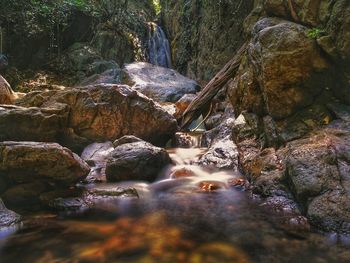 River flowing amidst rocks in forest