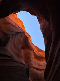 Looking up at a carved sandstone slot canyon inside lower antelope canyon in page, arizona 
