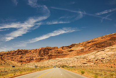 Road by mountain against sky