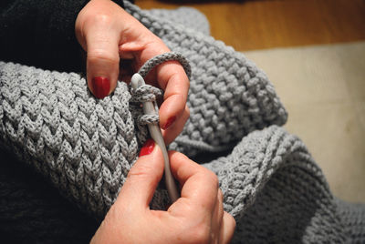 Close-up of woman weaving sweater