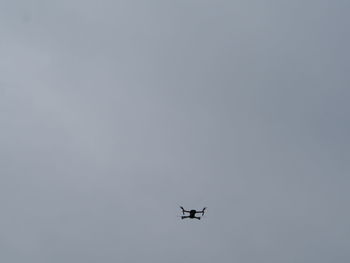 Low angle view of airplane flying against clear sky