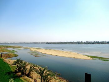Scenic view of lake against clear blue sky