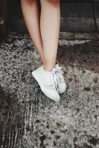 Low section of woman standing on ground