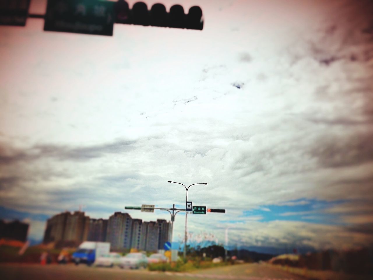 building exterior, flying, architecture, built structure, sky, transportation, airplane, cloud - sky, bird, mode of transport, animal themes, city, mid-air, animals in the wild, low angle view, air vehicle, cloud, dusk, cloudy, selective focus