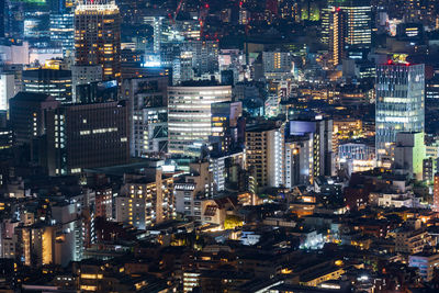 High angle view of city lit up at night