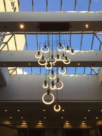 Low angle view of illuminated light bulbs hanging from ceiling