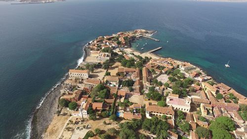 High angle view of cityscape by sea against sky