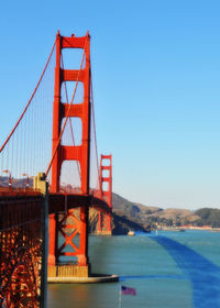 View of suspension bridge against blue sky