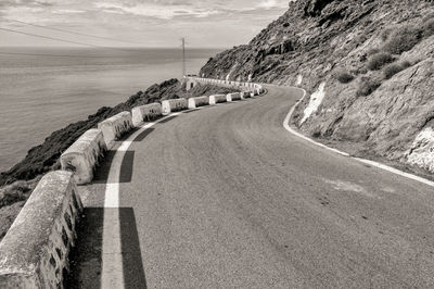 Road by sea against sky