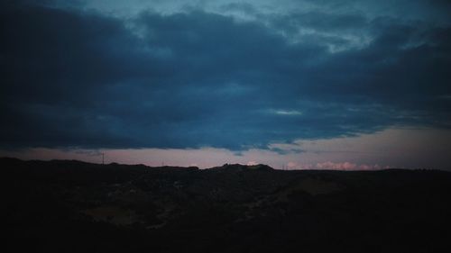 Silhouette landscape against sky