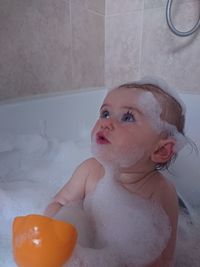 Baby girl in bubble bath 