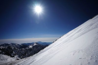 Scenic view of snow covered mountains against sky