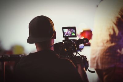 Rear view of man photographing