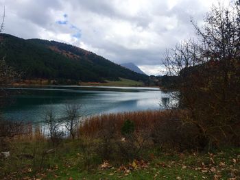 Scenic view of lake against cloudy sky