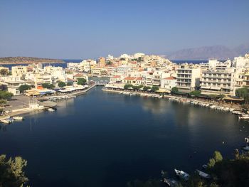 River amidst buildings against clear blue sky