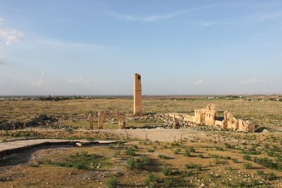 Old ruins on field against sky